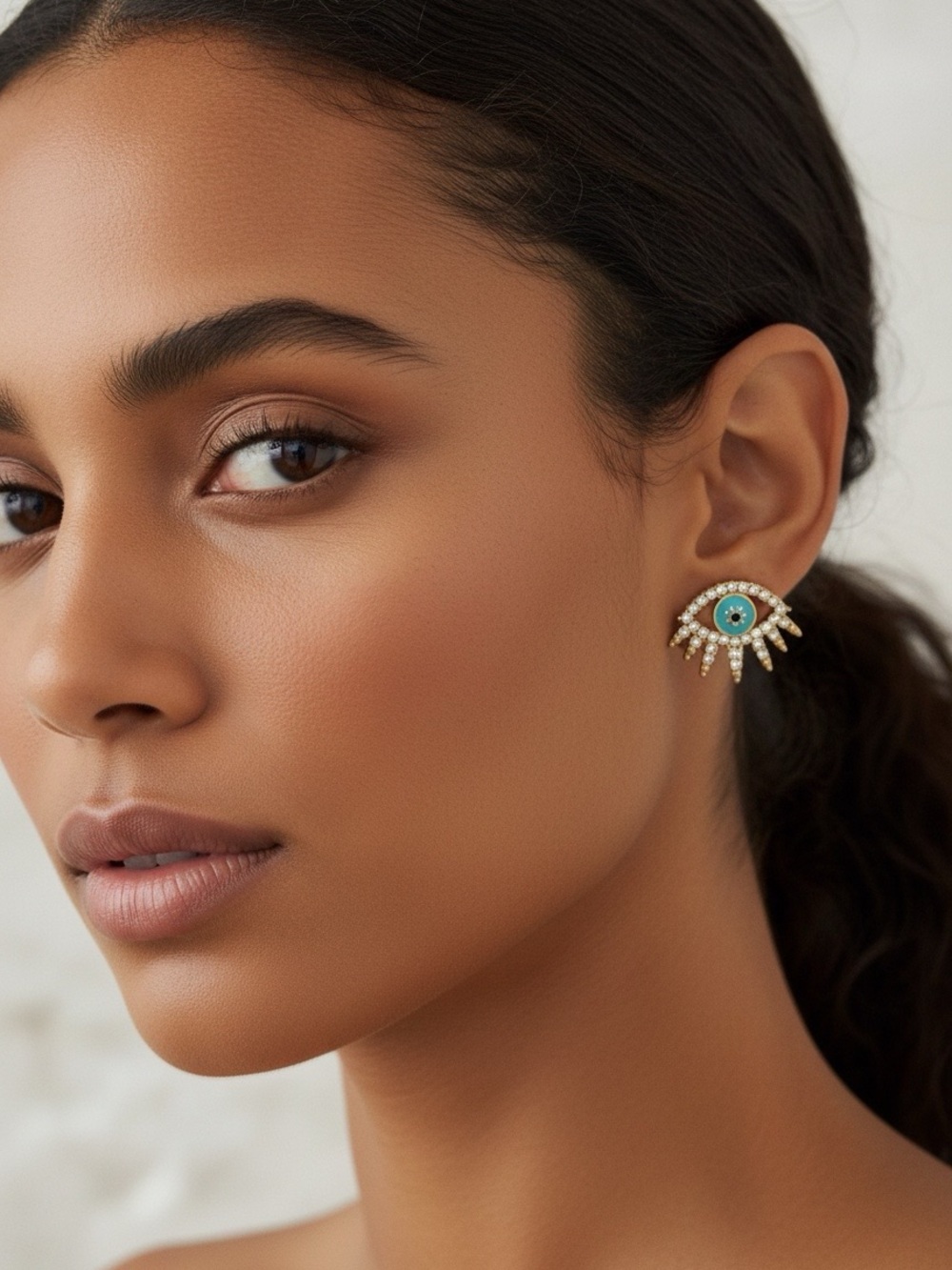 Evil Eye Faceted Gold Tone Stud Earrings.
